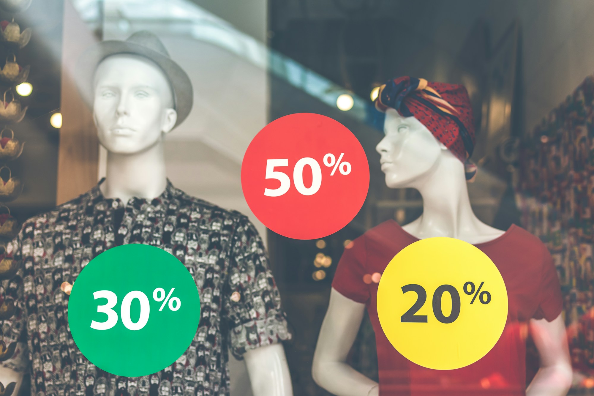 Two mannequins dressed in clothing in a retail store