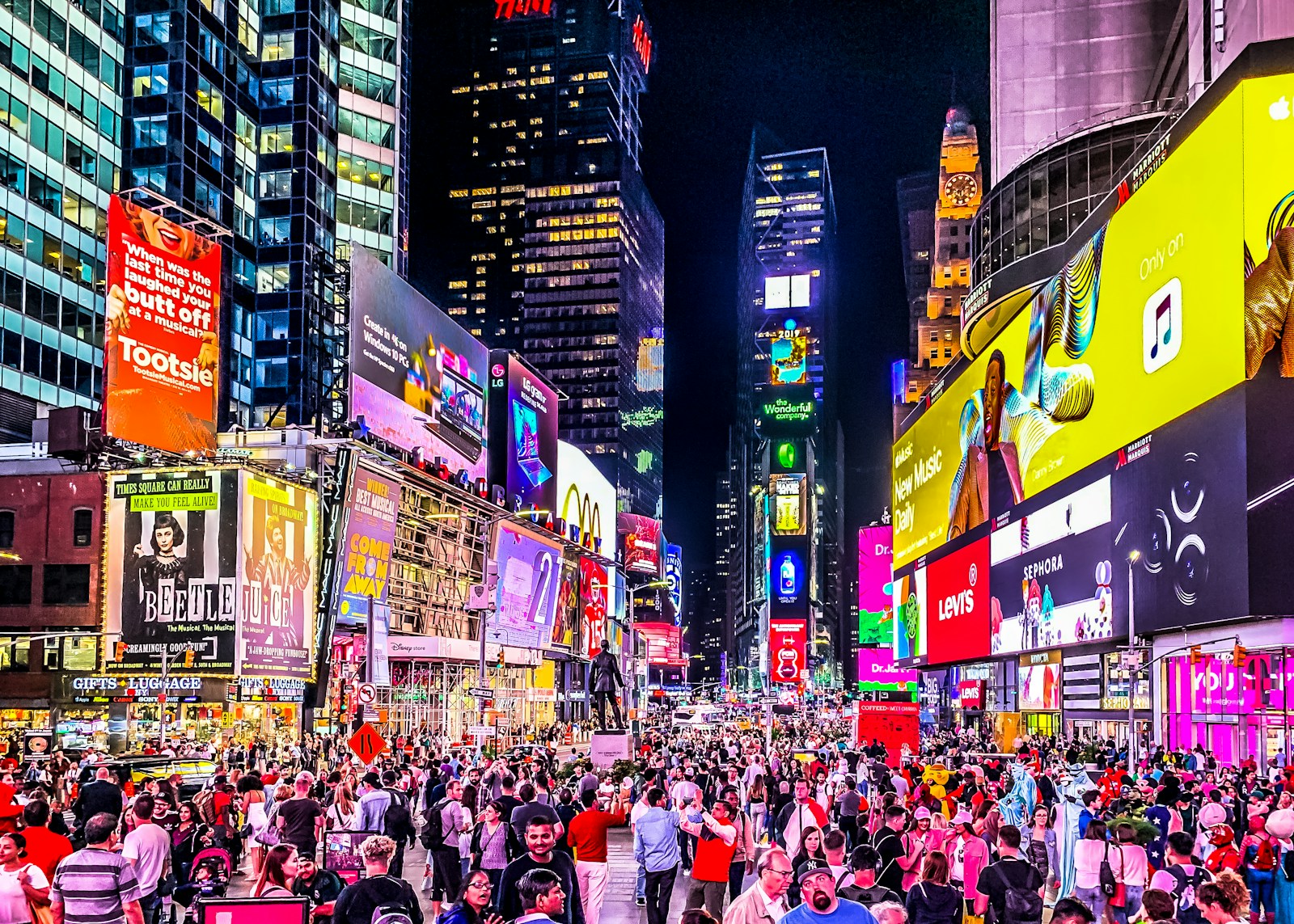 People walking on a city street at night